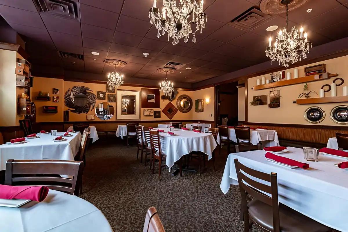 The CHAR Grillhouse dining room with white tablecloths and chandeliers