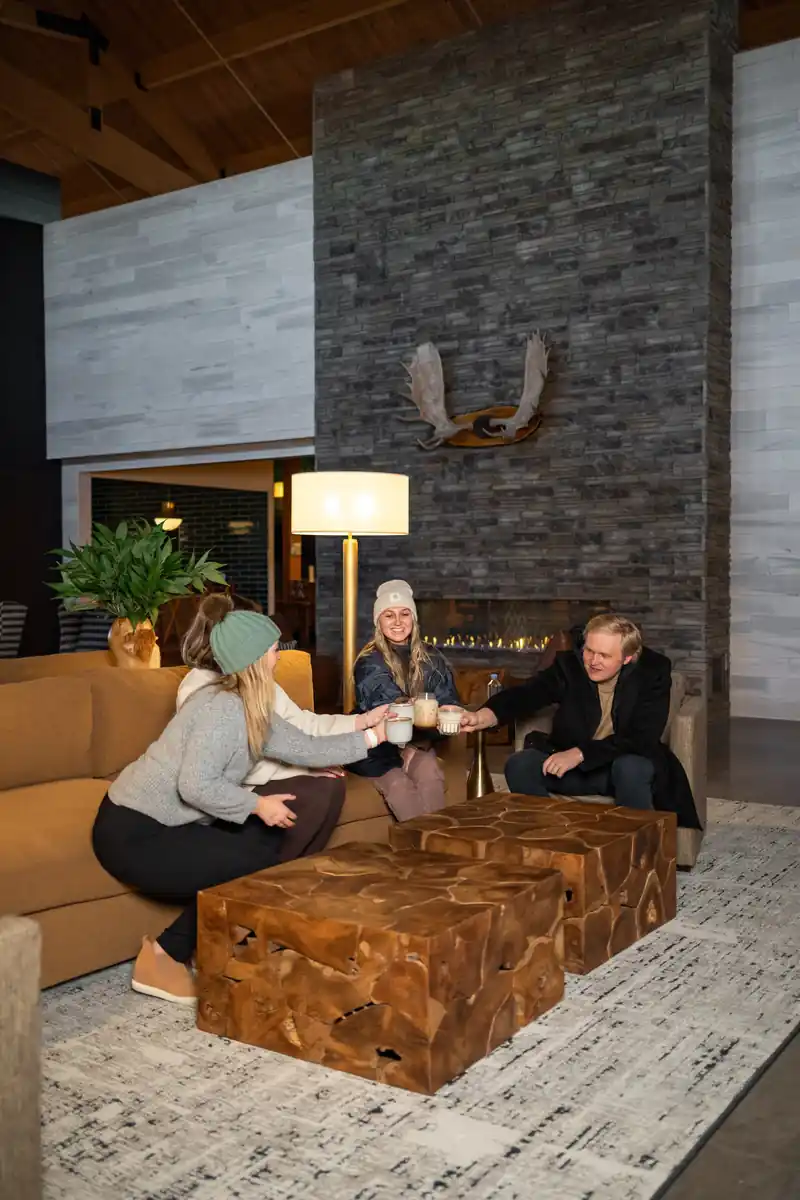 Friends by the stone fireplace in the lobby
