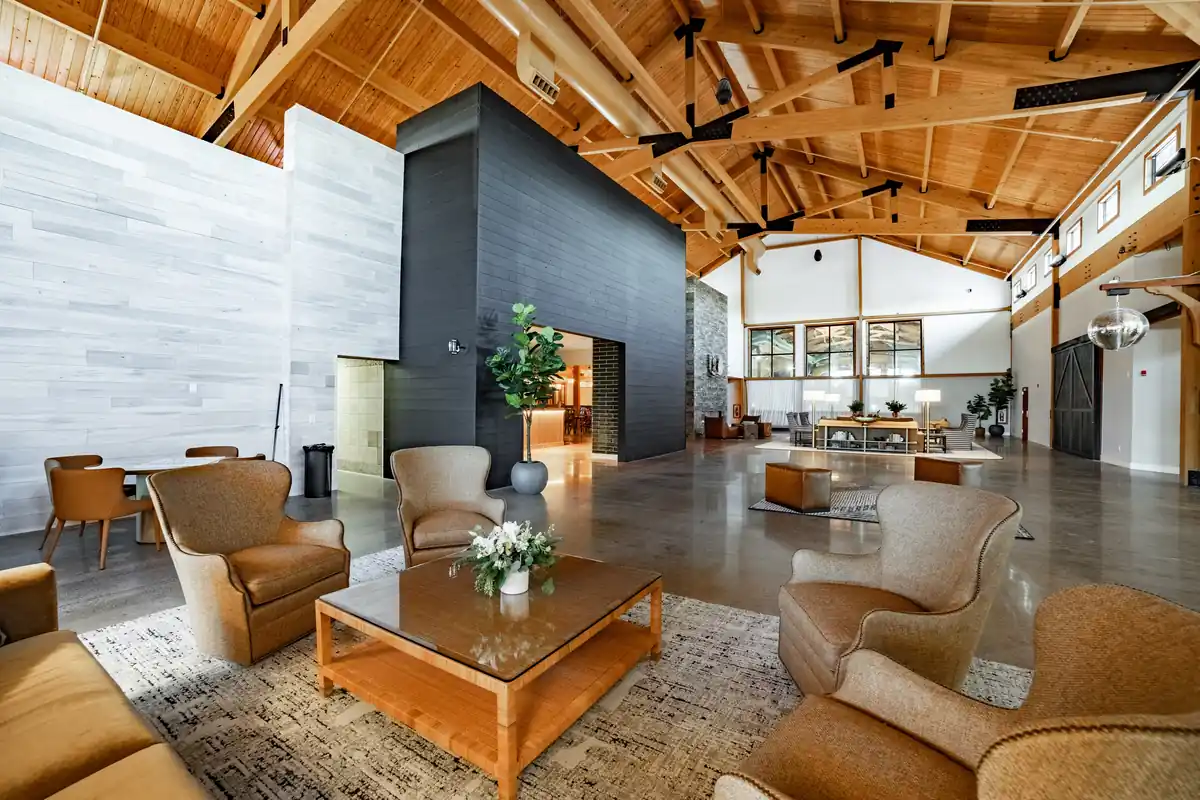 Timber-beamed great room with a fireplace at bantr rothschild