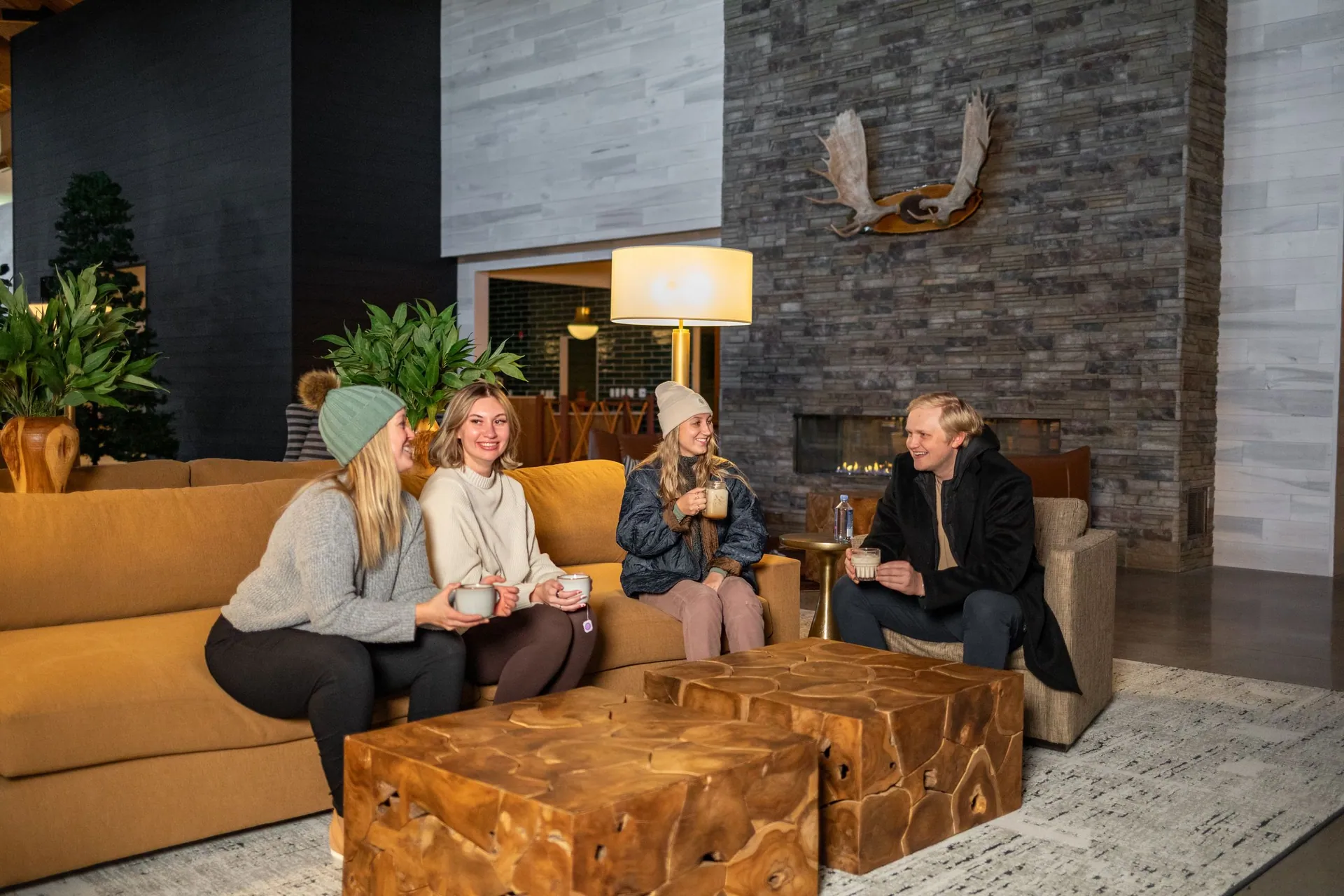 Guests relaxing by the fireplace in the bantr grand hotel lobby