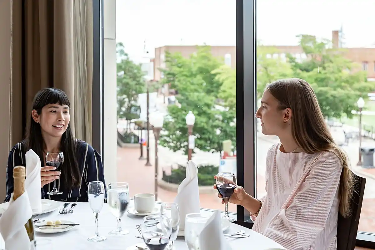 Friends dining by the window overlooking downtown