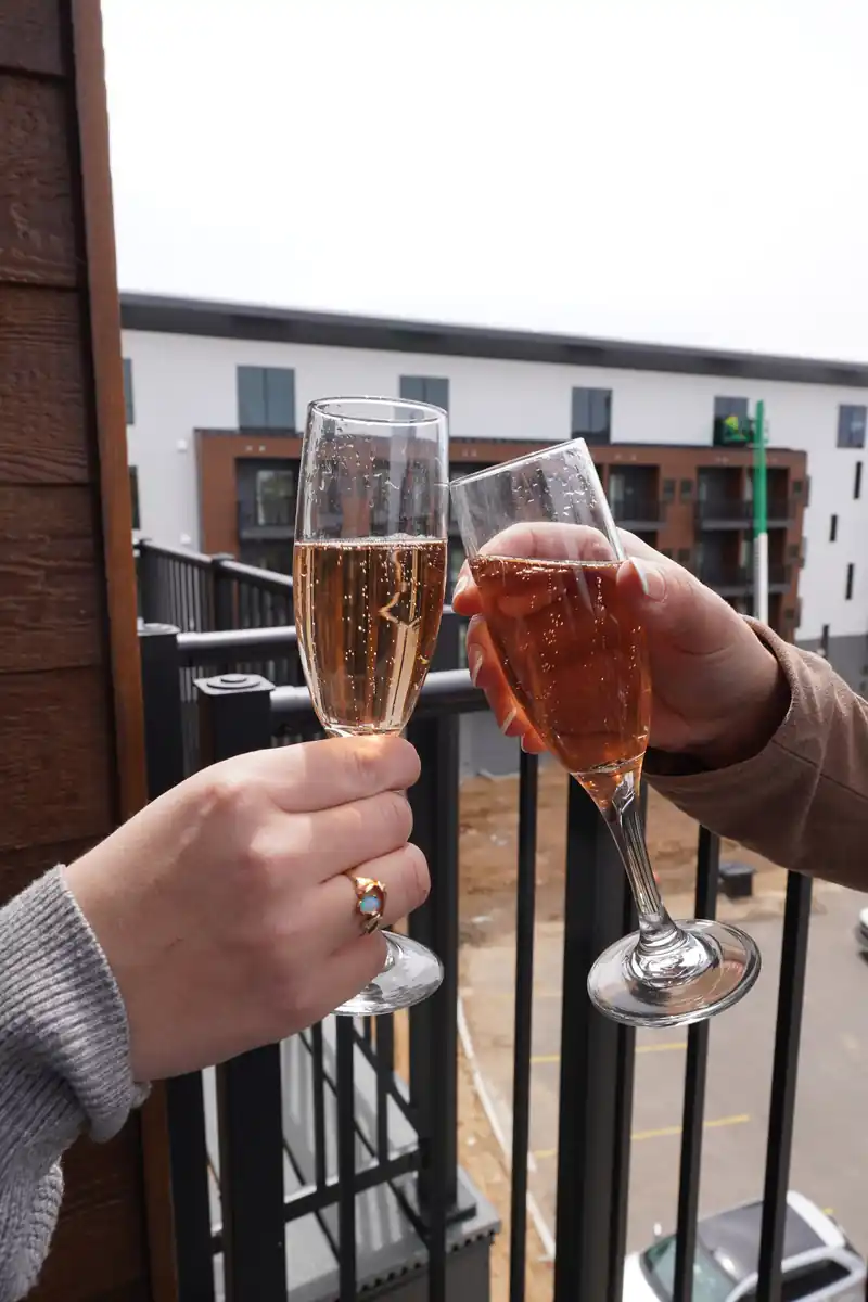 Residents raising glasses on a balcony at bantr wausau